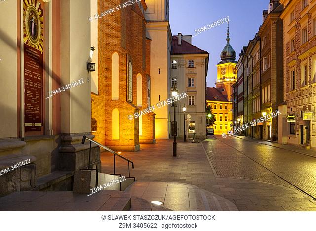 Dawn in Warsaw old town, Poland. Royal Castle tower in hte distance