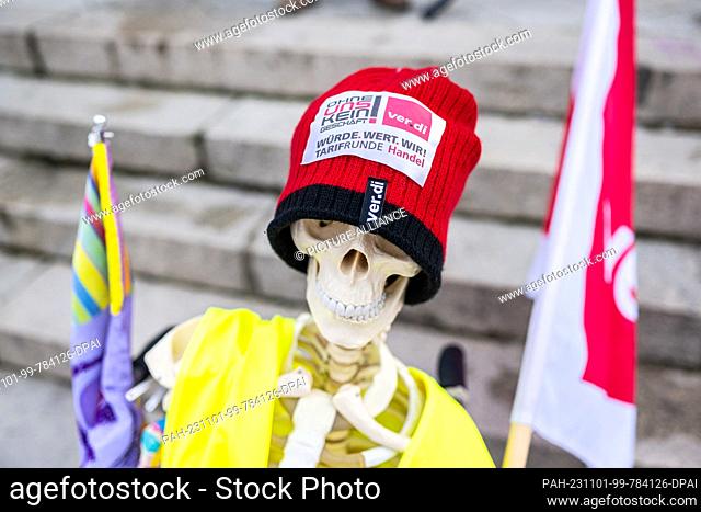 01 November 2023, Lower Saxony, Osnabrück: A skeleton with a cap and the inscription: ""No business without us"", stands at the central rally for Lower Saxony...