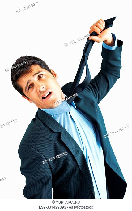 Man in suit holding up tie to strangle himself
