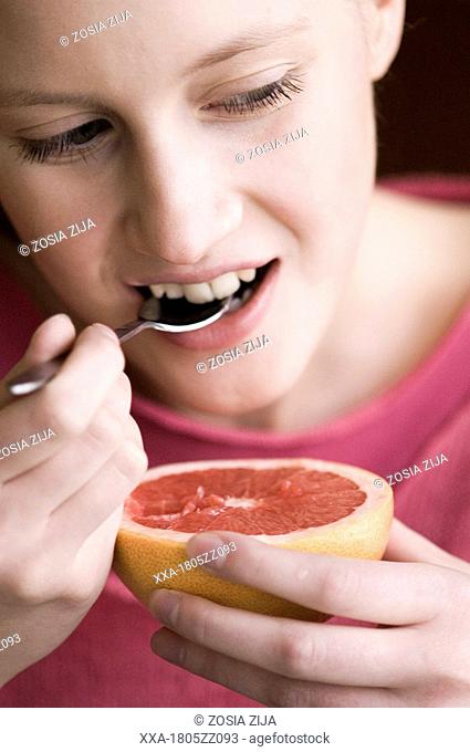 girl eating grapefruit