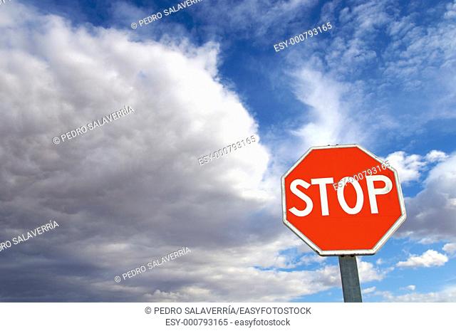 stop signal with cloudy sky
