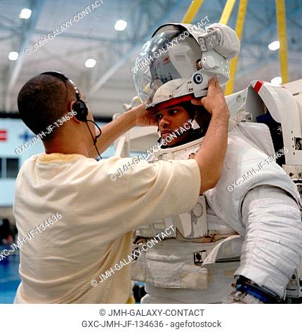Astronaut Robert L. Curbeam, Jr., is assisted by Robert (Nick) Barnett prior to an underwater training session in the Neutral Buoyancy Laboratory (NBL) at the...