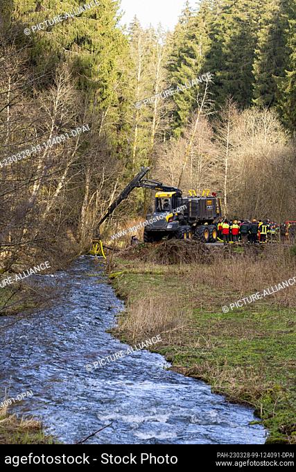 28 March 2023, Thuringia, Altenfeld: A special firefighting unit for forestry vehicles takes on water for a forest fire extinguishing exercise