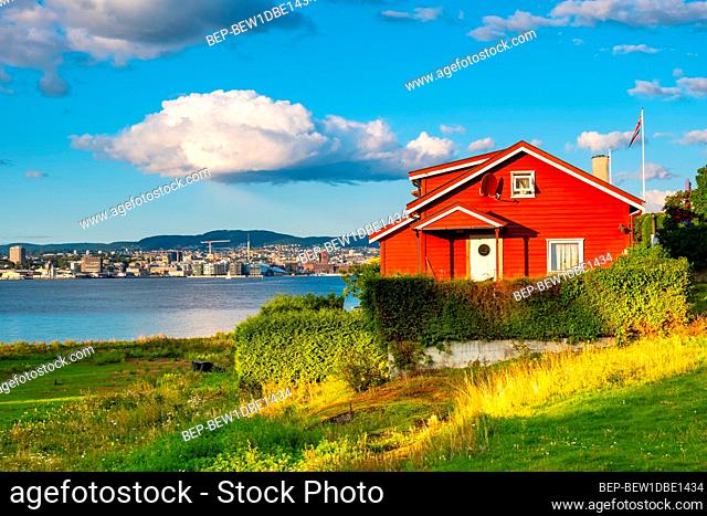 Oslo, Ostlandet / Norway - 2019/09/02: Panoramic view of Nakholmen island on Oslofjord harbor with summer cabin houses at shoreline in early autumn