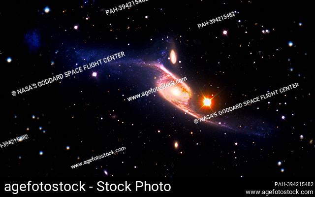This January 10, 2013, composite image of the giant barred spiral galaxy NGC 6872 combines visible light images from the European Southern Observatory's Very...