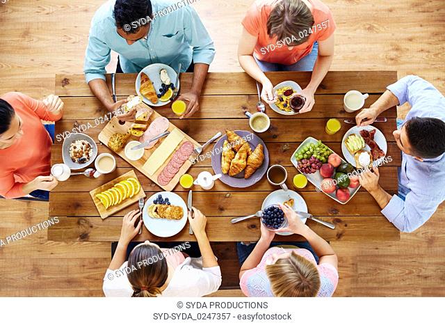 group of people having breakfast at table