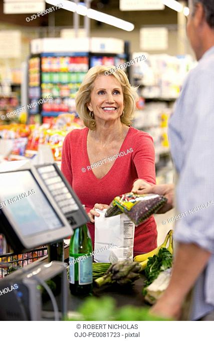 Woman buying groceries at supermarket