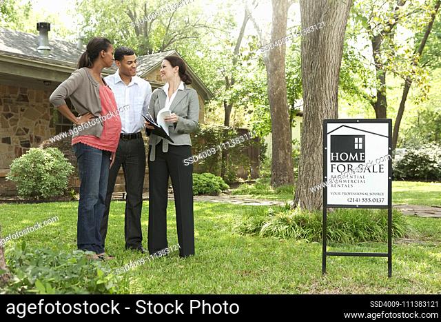Couple and realtor looking at home for sale