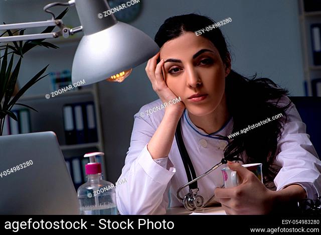 Young female doctor working at night shift