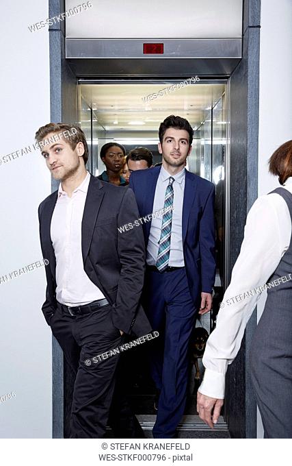 Germany, Neuss, Business people geting out of elevator