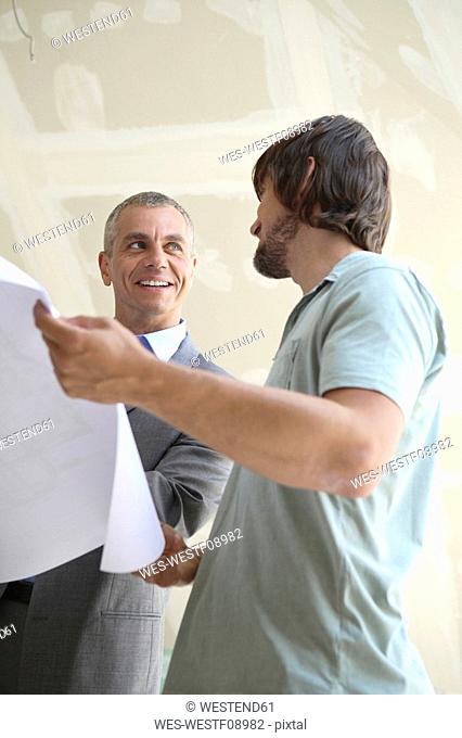 Two men looking at construction plan