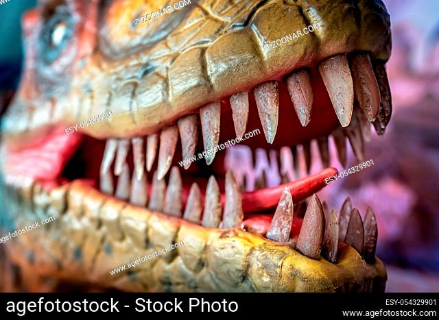 Open mouth showing sharp teeth of a Velociraptor dinosaur statue