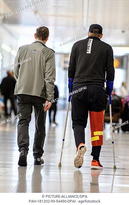 02 December 2018, Bavaria, München: Ski racer Thomas Dreßen (r) arrives at the airport in Beaver Creek after his heavy fall on the descent