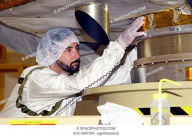 06/17/2002 -- A worker in the Space Assembly and Encapsulation Facility 2 SAEF-2 checks the base of the Comet Nucleus Tour CONTOUR spacecraft before it is moved...
