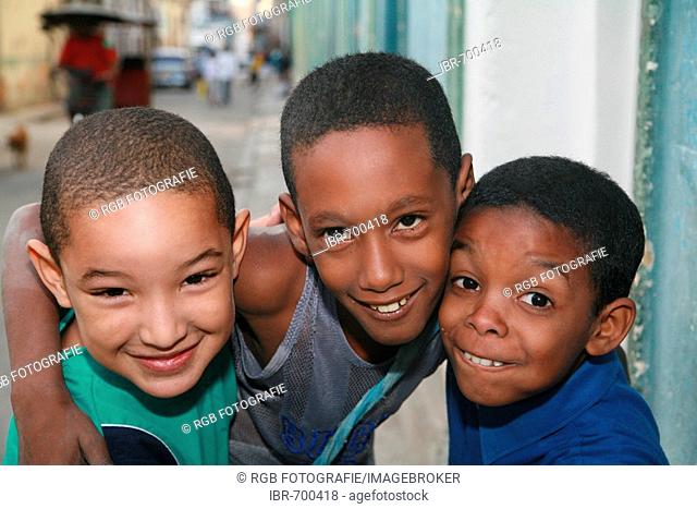 Three boys posing on the street in Havana, Cuba, Caribbean, Americas