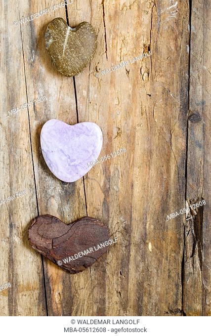three hearts on wooden ground