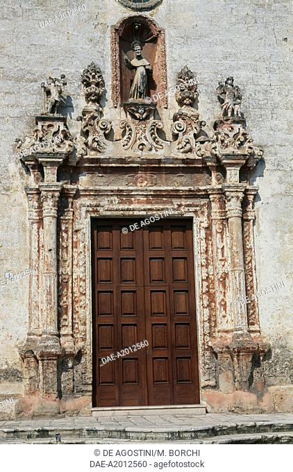 The portal of the Church of San Leonardo, with statues of St Christopher and St Raphael, St Leonard inside the central niche, Manduria, Salento, Apulia, Italy