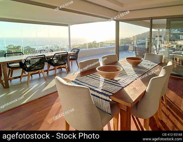 Sunny home showcase interior dining room with scenic ocean view