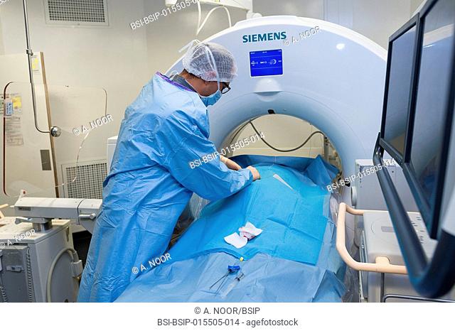 Reportage in the interventional scanner service in Pasteur 2 Hospital, Nice, France. Vertebroplasty- cementoplasty operation to treat a vertebral facture
