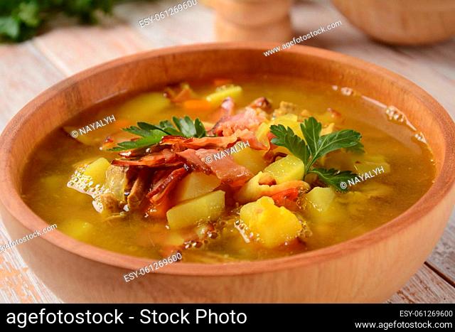 Lentil pea soup garnish with bacon, fried onion and croutons
