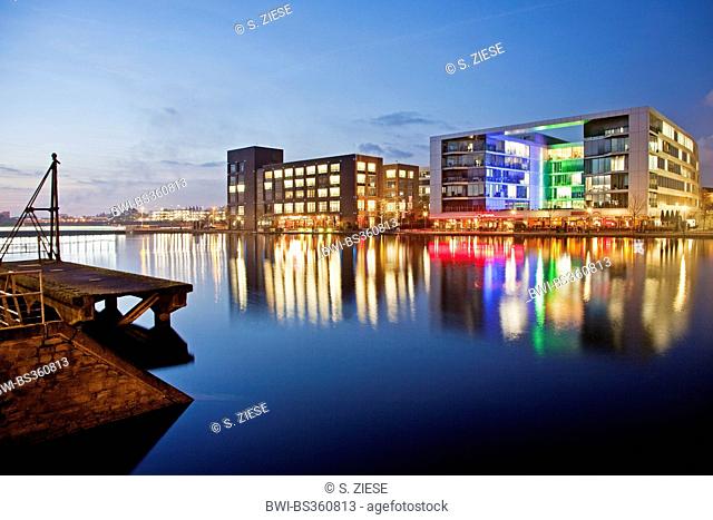 illuminated office buildings and gastronomy in harbour in the evening, Germany, North Rhine-Westphalia, Ruhr Area, Duisburg