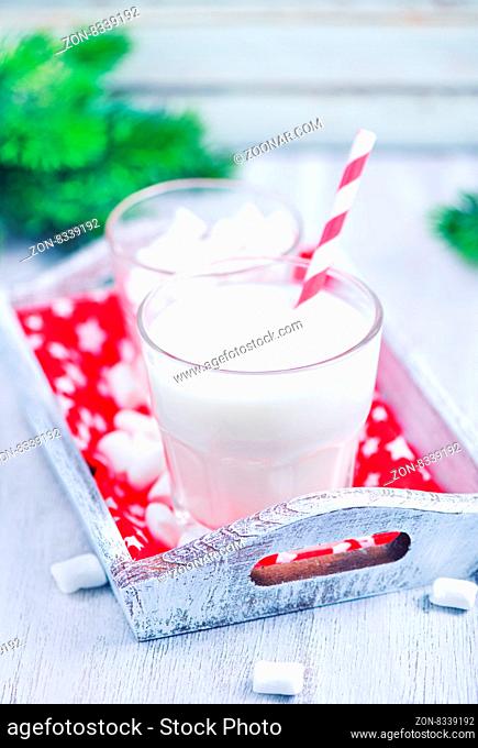 fresh milk and marshmellow on white tray and on a table