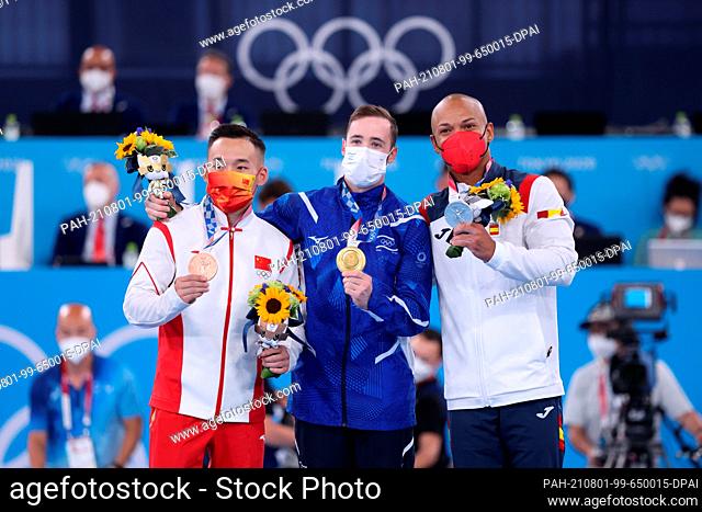 01 August 2021, Japan, Tokio: Gymnastics: Olympics, floor, men, final. China's Xiao Ruoteng (l-r) with bronze medal, Artem Dolgopyat from Israel with gold medal...