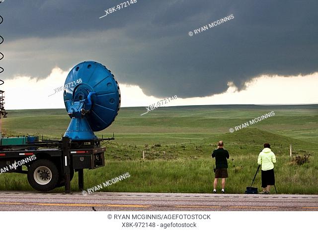 Storm chasers with Project Vortex 2 watch a distant wall cloud and supercell in Goshen County, Wyoming, June 5, 2009  The truck at left is the 'Doppler on...