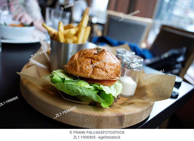 Close up of a Hamburger on wood plate shallow depth of field