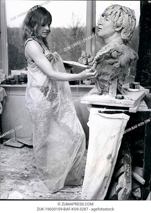 1968 - Working in clay is dusty work - hence the plastic wrapping round sculptress Liz Moore while she works on a bust of Beatle John in her Surrey studio
