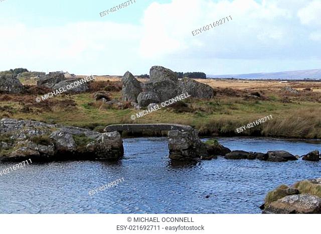 A rural landscape with a rock footbridge