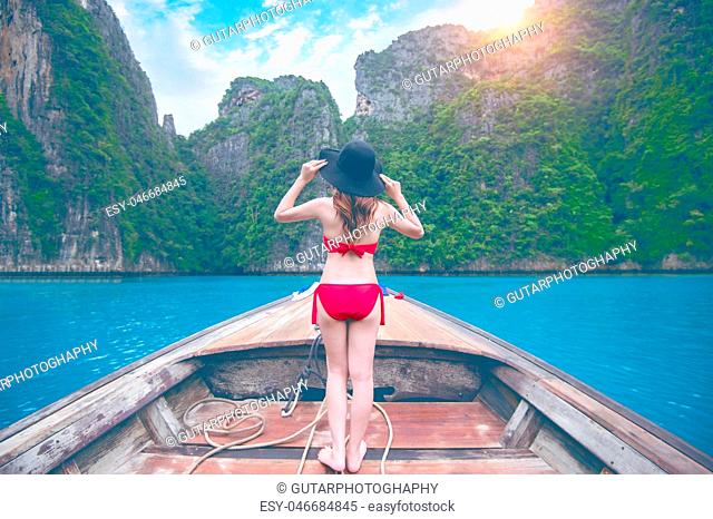 Beautiful girl in red bikini on boat