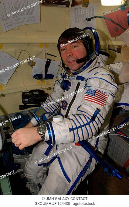 NASA astronaut Michael Barratt, Expedition 20 flight engineer, attired in a Russian Sokol launch and entry suit, is pictured in the orbital module of the Soyuz...
