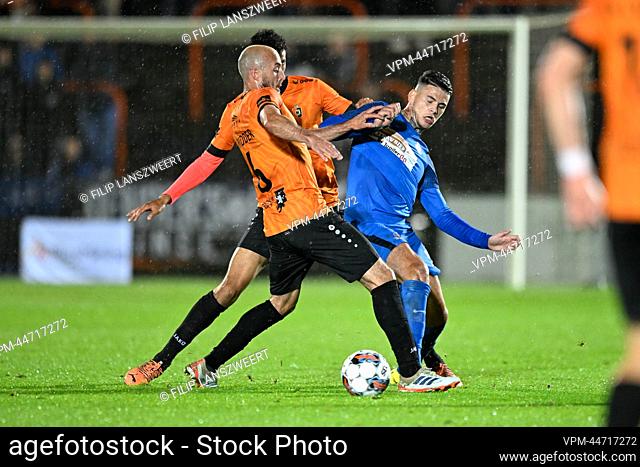 Deinze's Steve De Ridder and Dender's Suer Barbaros Cukur Tiago fight for the ball during a soccer match between KMSK Deinze and Dender EH