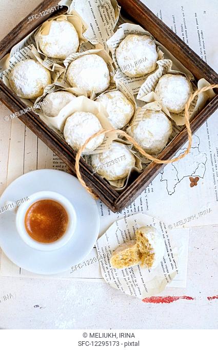 Walnut cookies covered in icing sugar and served with an espresso