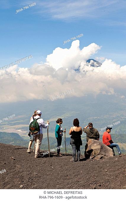 Climbing Pacaya volcano, with Fuego Volcano in distance Antigua, Guatemala, Central America