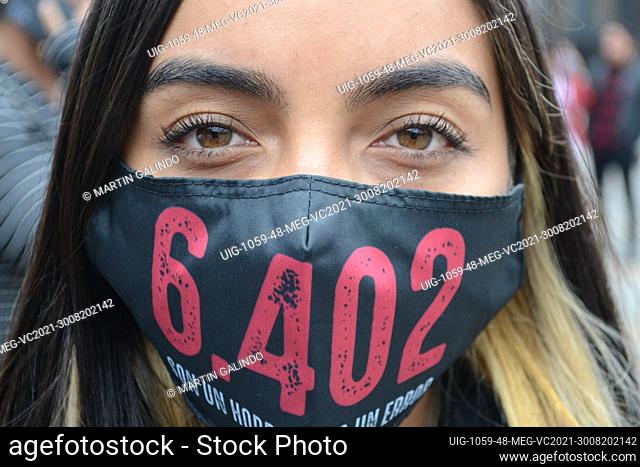 A young activist wears a mask with the number 6402, in rejection of the more than 6, 402 murders of innocent civilians committed by the Colombian army during...
