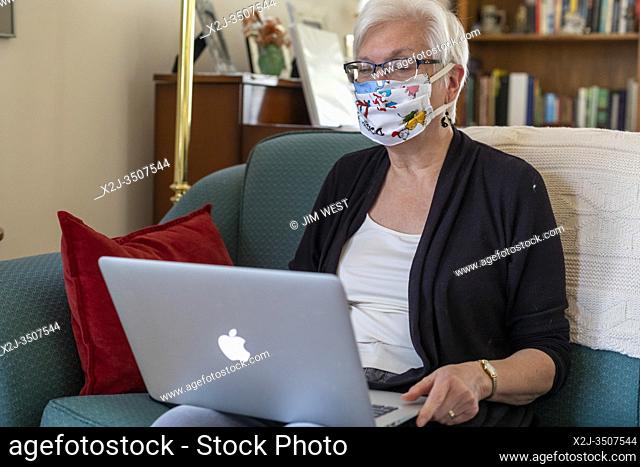 Detroit, Michigan USA - 8 April 2020 - Susan Newell, 71, wears a homemake face mask for protection against the coronavirus while part of a Zoom meeting