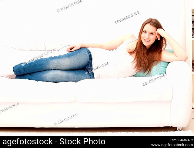 Full-length portrait of a young woman lying on her pillow