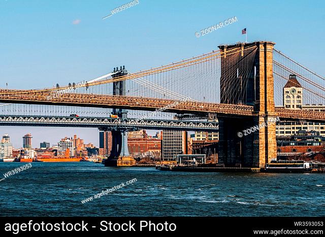 New York City - USA - Mar 11 2019: View down to Brooklyn Bridge and Manhattan Bridge from east river side in Lower Manhattan New York City