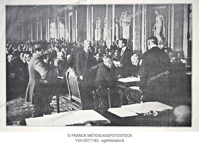 Newspaper photograph representing the US president Woodrow Wilson ( seated seen from the rear) signing the Treaty of Versailles in the palace of Versailles (...