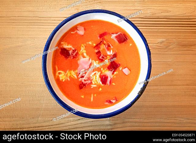 Salmorejo, Spanish cold tomato soup, shot from the top on a wooden background