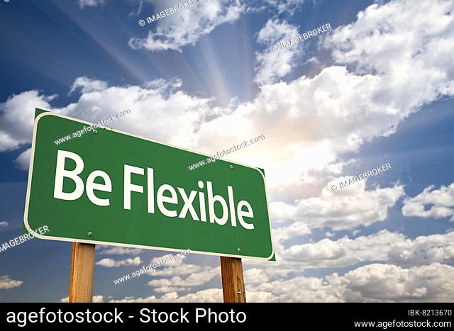 Be flexible green road sign with dramatic clouds and sky