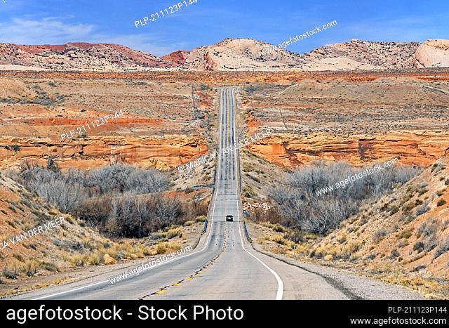 Lonely car driving on the U.S. Route 191 / US 191 highway through Utah's Red Rock Country to Bluff, San Juan County, United States, USA