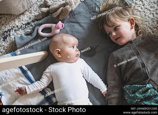 Girl with baby sibling looking at each other