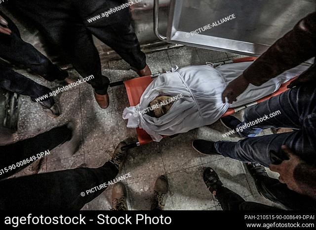 15 May 2021, Palestinian Territories, Gaza City: The body of a Palestinian child who was killed after an Israeli airstrike is seen inside the morgue of Al-Shifa...