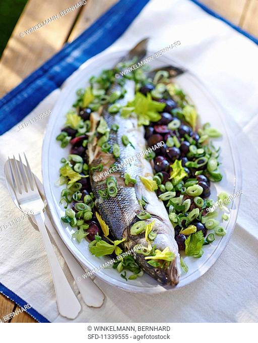 Sea bass on a celery and onion salad with black olives