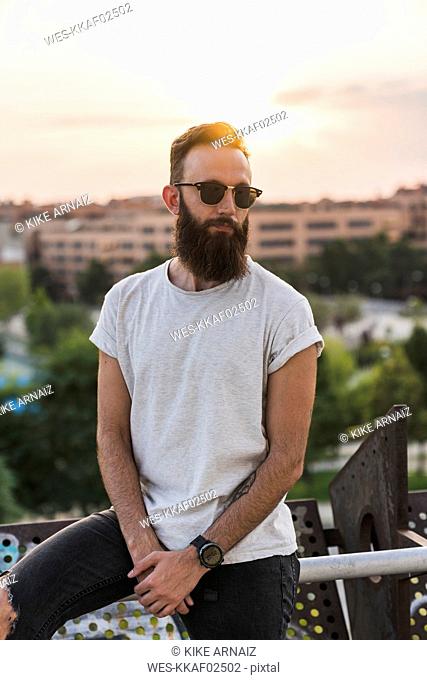 Cool bearded young man wearing sunglasses