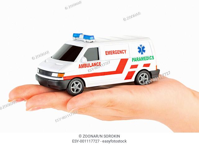 Hand with toy ambulance car