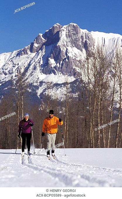 Young couple cross-country skiing in Fernie, Elk Valley, East Kootenays, British Columbia, Canada